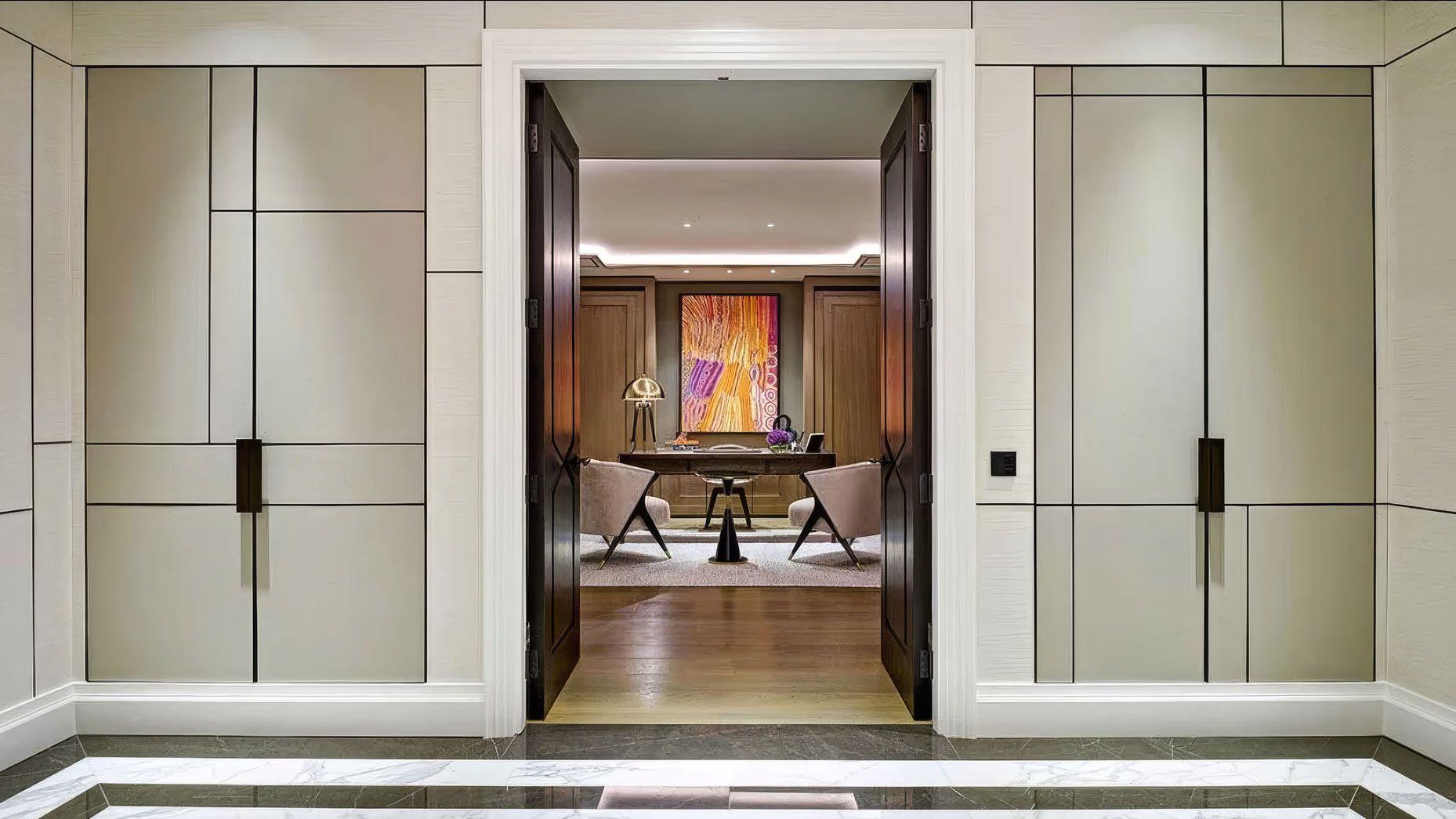 Krailler Interiors — panelled hallway opening onto a study with a vivid abstract painting.