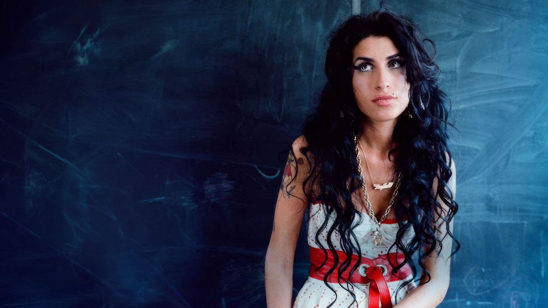 Amyspace — portrait of Amy Winehouse against a dark blue chalkboard wall.